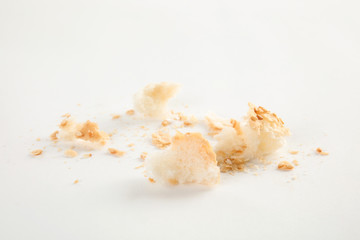 Obraz na płótnie Canvas Scattered bread crumbs on white background, closeup