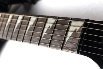 closeup of fret frets on an electric guitar on a white background