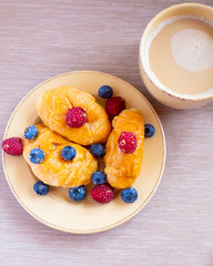 fresh juicy summer berries raspberry and blueberry with drops of honey in a natural beige cotton cloth. 