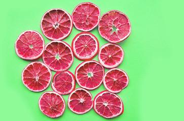 Dried slices of orange on colorful background.