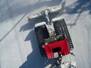 High Angle View Of A Pistenbully Snowcat Operation From A Drone