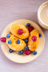 fresh juicy summer berries raspberry and blueberry with drops of honey in a natural beige cotton cloth. 