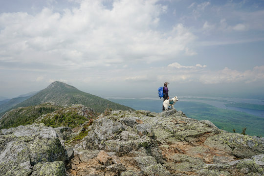 Side view of woman hiking with dog on Avery Peak