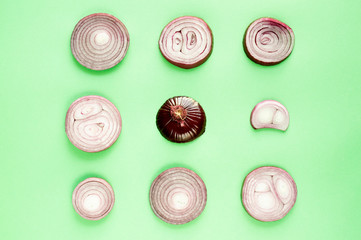 Sliced red onions over green background