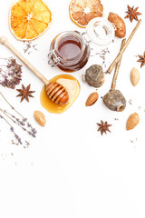Wooden spoon for honey, herbs, nuts and spices on a white background. Top view.
