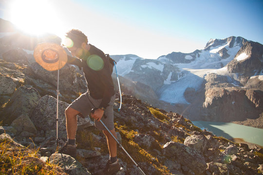 A hiker holds his straw hat while hiking around the Wedgemount Lake area in Garibaldi Provincial Park.