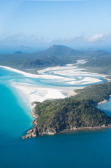aerial view over whitsunday island beach with blue sunny sky and white sand at whiteheaven beach,...