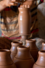 ceramic workshop - the man  makes a pot of clay on a potter's wheel