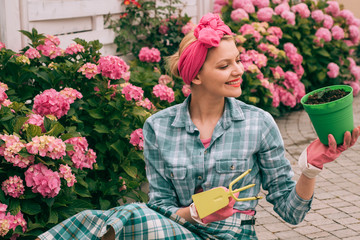 woman care of flowers in garden. Flower care and watering. soils and fertilizers. hydrangea. Spring and summer. happy woman gardener with flowers. Greenhouse flowers. Look at it