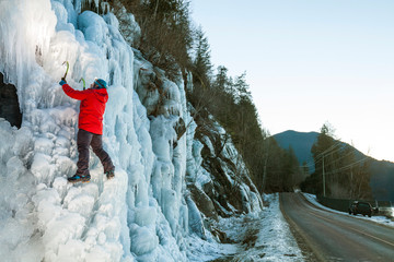 Person in red jacket climbing on hill in ice