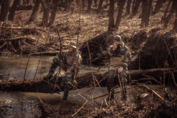 Hunters resting in forest during hunting season 