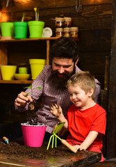 Father and son. Fathers day. Family day. Greenhouse. Flower care watering. Soil fertilizers. happy...