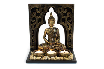 Buddha sculpture with golden color in decorative frame with candles and stones and with overall vintage look isolated on white background