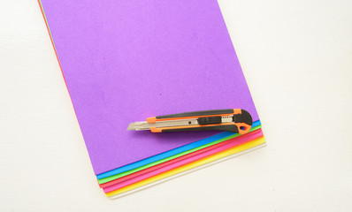 Few colorful sheets of eva foam with  Snap Off Blade Knife