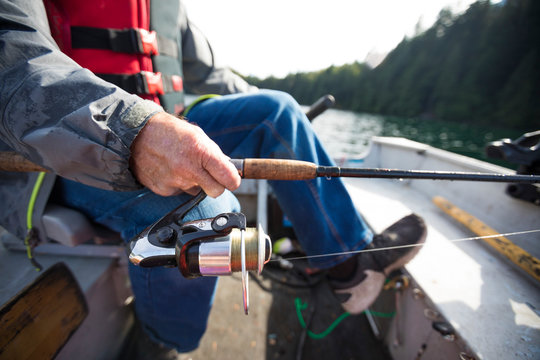 Close up of fishing rod of fisherman, Hicks Lake, Harrison Hot Springs, British Columbia, Canada