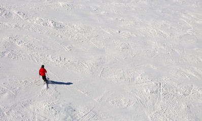 skier in the slope in the white snow in mountain