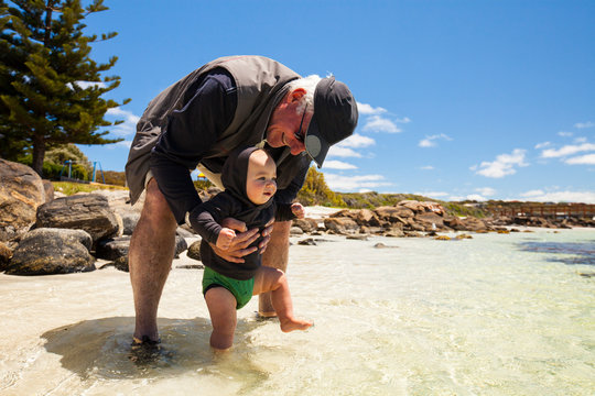 Grandfather With Baby Boy At Beach