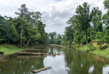 Fototapeta na wymiar Artificial moat dug around the Angkor Thom (Bayon) complex at Angkor near Siem Reap in Cambodia
