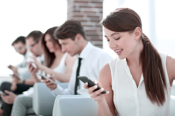 young employee looking at text message on smartphone