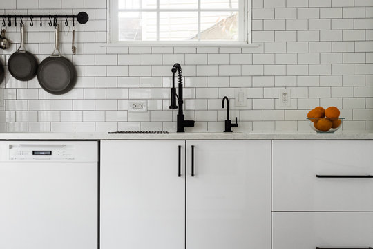 Kitchen sink and white subway tile backsplash