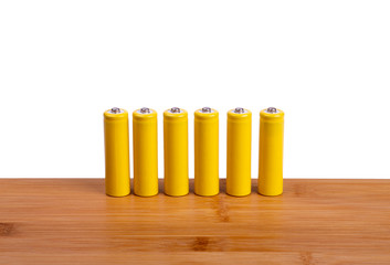 a row of yellow batteries on a white background