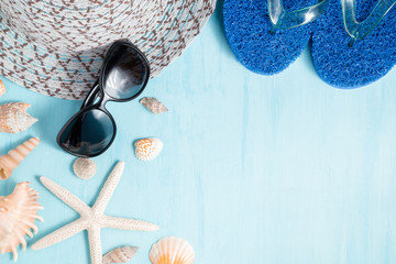 Blue sea background with hat, sunglasses and seashells, summer holiday and vacation time concept