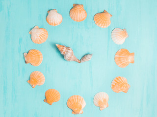 Blue sea background with clocks from seashells, summer holiday and vacation time concept