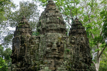 Giant face sculpture on top of the North Gate of the Angkor Thom complex in Cambodia