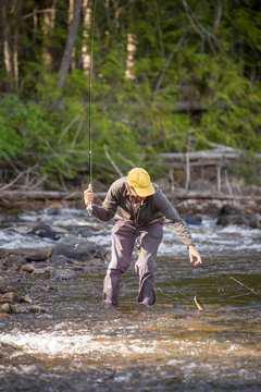 Angler Jake Wells releases an inland redband rainbow trout (native fish) in NW Montana's Yaak River.