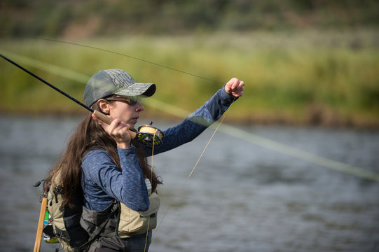 Woman fishing in river