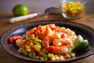 Shrimps with cauliflower, mango avocado, red paprika pepper and lime. horizontal