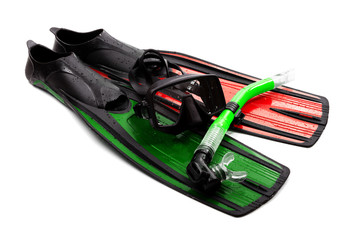 Mask, snorkel and swim flippers of different colors with water drops