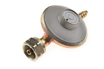 Regulator for propane-butane gas cylinder and accessories on a wooden workshop table. Gas...