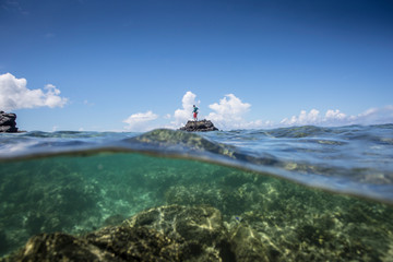 Angler Jonathan Jones stands on a reef outcropping while fly fishing inshore in Samoa.