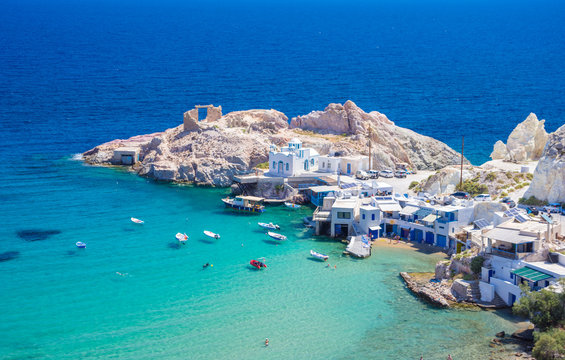 Scenic Firopotamos village (traditional Greek village by the sea, the Cycladic-style) with sirmata - traditional fishermen's houses, Milos island, Cyclades, Greece.