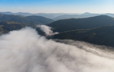aerial view of mountain above clouds. Romaniaaerial view of mountain above clouds. Romania