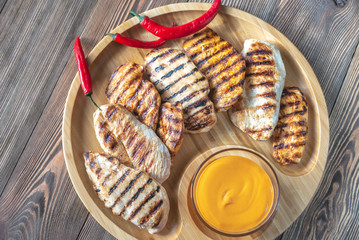 Grilled chicken breast on the wooden tray