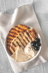 Grilled chicken breast with black olives and tahini sauce