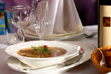 Soup in a white plate on a table in a restaurant