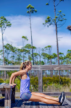 A young woman exercises on a Florida beach. 