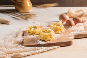 Fototapeta na wymiar Making homemade pasta on rustic kitchen table 