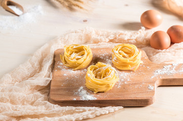 Making homemade pasta on rustic kitchen table 