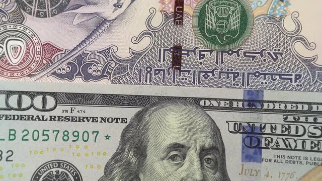 UAE dirham against US dollar bill rotating. United Arab Emirates and USA trade. 4K stock video footage