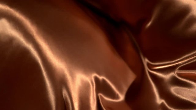 Bronze wavy fabric background in super slow motion, 4K