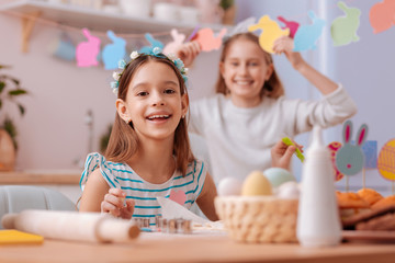 Amazing longhaired child sitting on the foreground