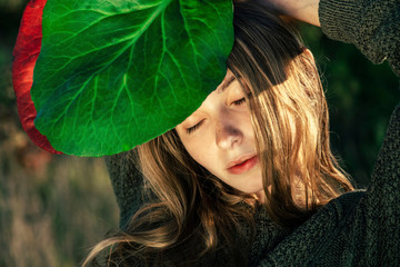 Woman with eyes closed in sunlight