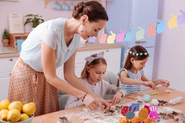 Cute girls doing cookies with their mom