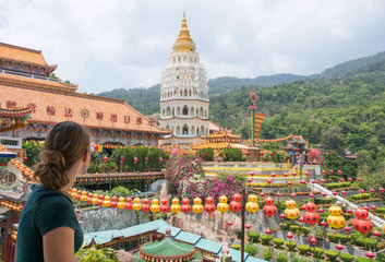 woman looking at colorful buddhisum temple in penang malaysia asia
