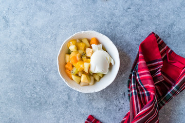 Fruit Salad with Vanilla Ice Cream in Ceramic Bowl.