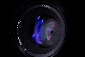 Lens aperture low light photo closeup. Colorful light traces on glass. Aperture blades is clean and...